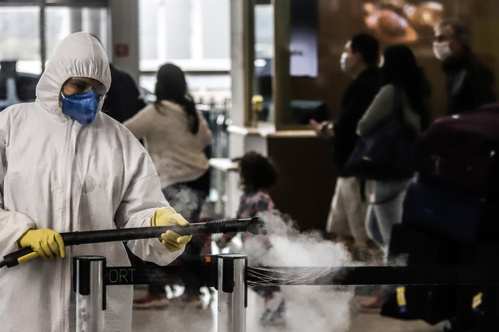 A staff member disinfects the Guarulhos International Airport on the outskirts of Sao Paulo, Brazil, July 30, 2020.  (Photo by Rahel Patrasso/Xinhua)