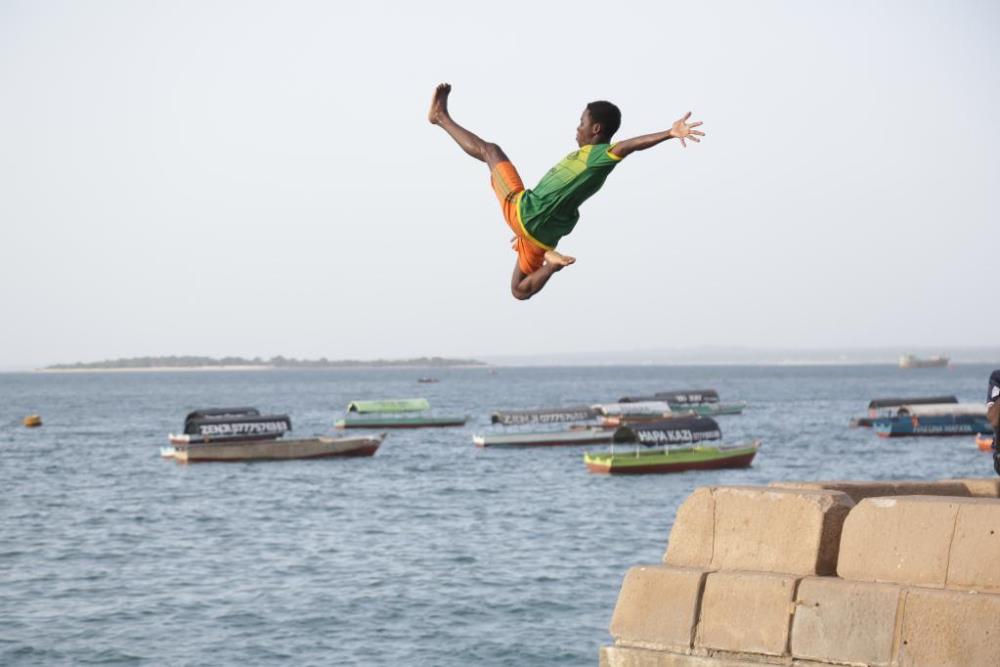 A young man jumps into the sea for fun at Zanzibar, Tanzania on Feb. 11, 2022. (Photo by Herman Emmanuel/Xinhua)