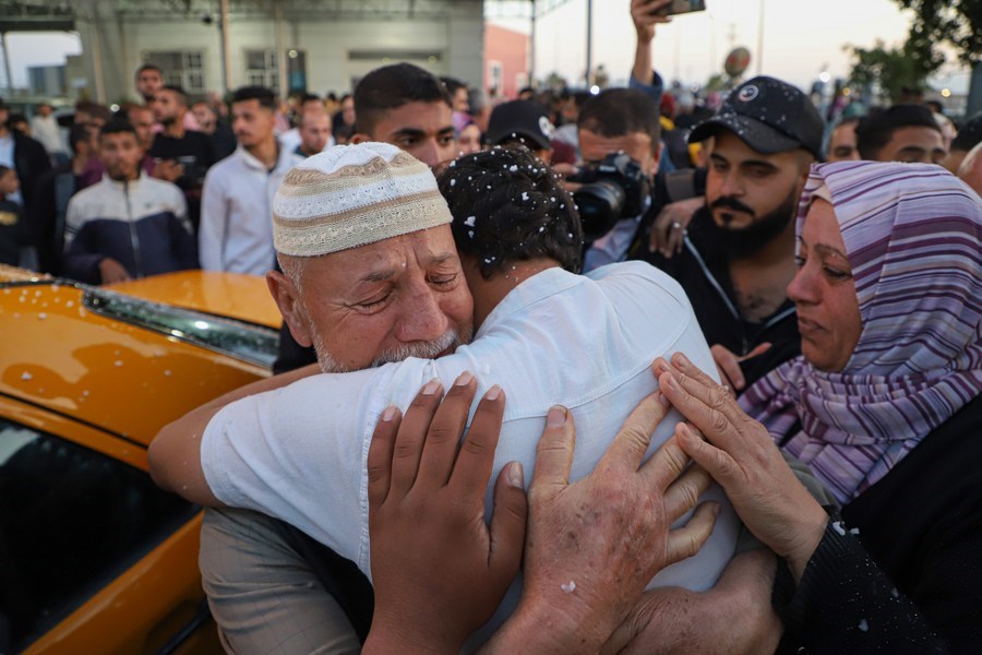 A Palestinian evacuated from Sudan is welcomed by his relatives at the Rafah Border Crossing in the southern Gaza Strip city of Rafah, on April 28, 2023. (Photo by Rizek Abdeljawad/Xinhua)