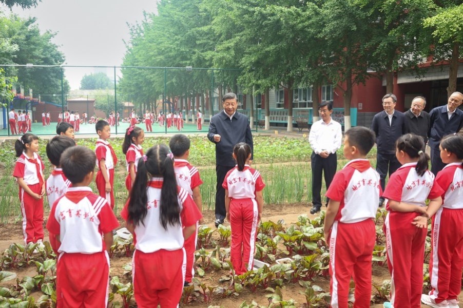 Chinese President Xi Jinping, also general secretary of the Communist Party of China Central Committee and chairman of the Central Military Commission, talks with students at the students' farm of Beijing Yuying School in Beijing, capital of China, May 31, 2023. (Xinhua/Ju Peng)