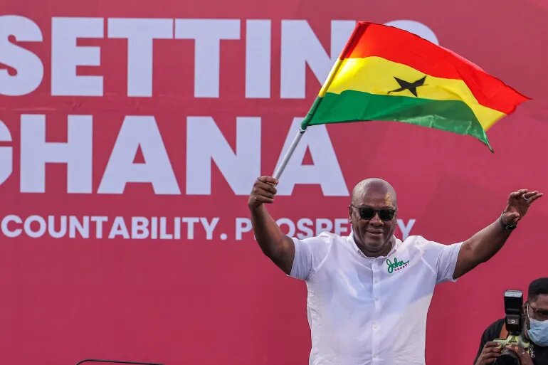 National Democratic Congress (NDC) presidential candidate and former Ghanaian President John Dramani Mahama holds a national flag as he waves to supporters during his final election campaign rally in Accra, Ghana December 5, 2024.