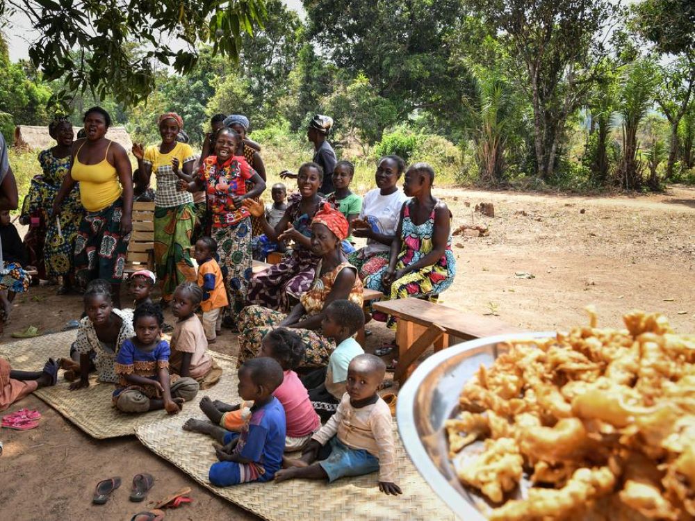 Villagers wait to be served with freshly fried mushrooms in Gba village of Bangui, the Central African Republic, Feb. 5, 2024. (Xinhua/Han Xu)