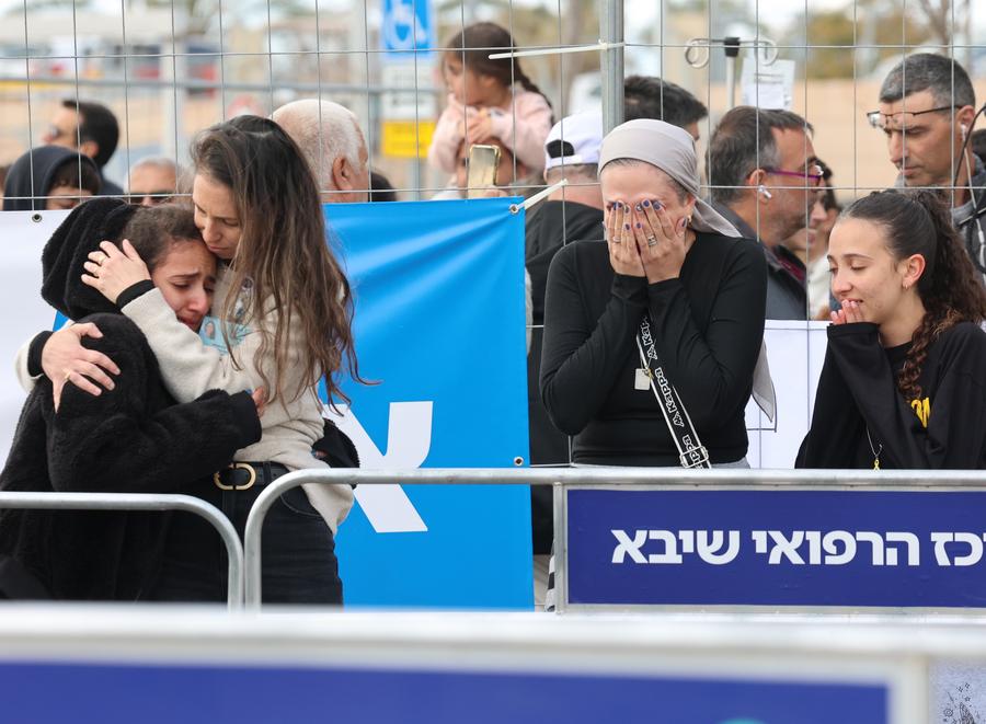 Relatives of a released hostage hug each other when a helicopter carrying the hostage arrives at a medical center in Ramat Gan, Israel, on Feb. 8, 2025. Israel and Hamas on Saturday completed the fifth prisoner-for-hostage swap under the first phase of the ongoing Gaza ceasefire agreement, according to Israeli and Palestinian sources. (Photo by Gil Cohen Magen/Xinhua)