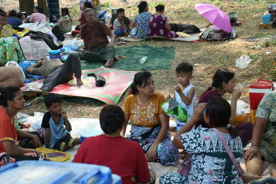 Quake-affected people sit on the ground in the open after an earthquake in Mandalay, Myanmar, March 29, 2025.