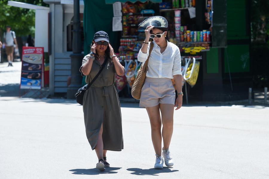People walk on a street during a heat wave in Madrid, Spain, May 29, 2025.