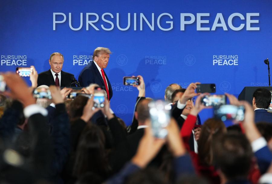 U.S. President Donald Trump (R, Rear) and Russian President Vladimir Putin (L, Rear) arrive for a joint press conference after concluding their talks in Anchorage, Alaska, the United States, on August 15, 2025.