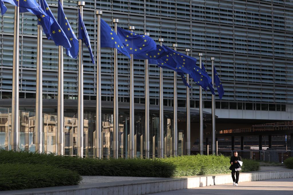 Photo taken on May 23, 2025 shows European Union flags at the European Commission headquarters in Brussels, Belgium. U.S. President Donald Trump on Friday threatened a 50 percent tax on all imports from the European Union as well a 25 percent tariff on Apple products unless iPhones are made in the United States.