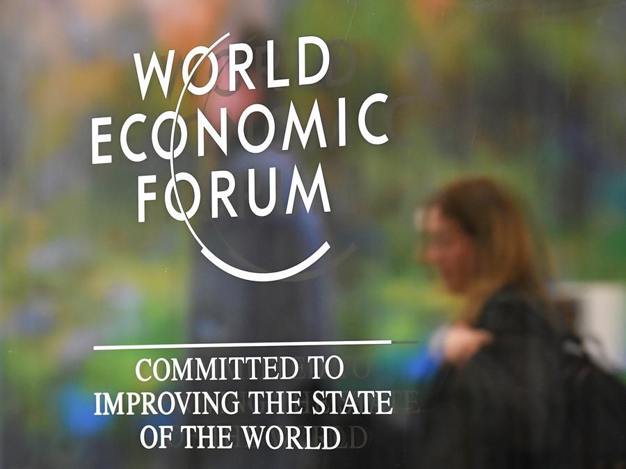 A participant walks past the logo of the World Economic Forum prior to the opening of its annual meeting, in Davos, Switzerland, January 18, 2026.