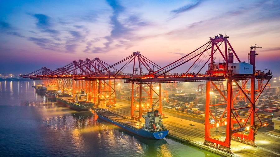 An aerial drone photo taken on Dec. 15, 2025 shows vessels loading and unloading containers at a container dock of Tangshan Port in Tangshan, north China's Hebei Province.