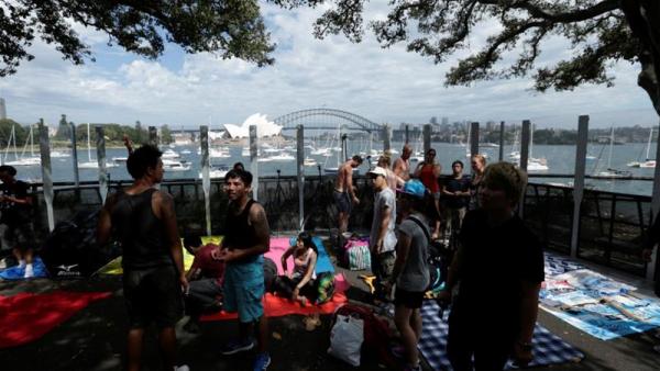 Early arrivals claim prime positions to watch fireworks in front of the Sydney Opera House