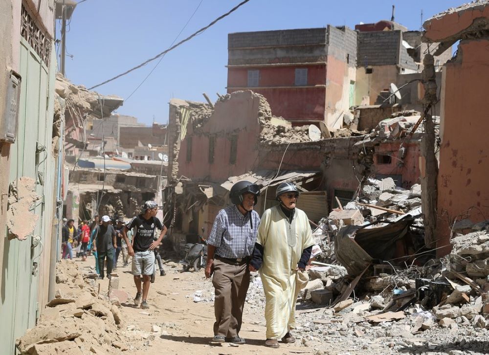 Residents pass by damaged buildings near the epicenter at Amizmiz Village in Morocco, Sept. 10, 2023.(Xinhua/Wang Dongzhen)