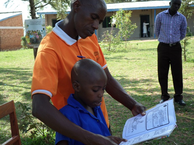 This Parent is helping her child to read a book