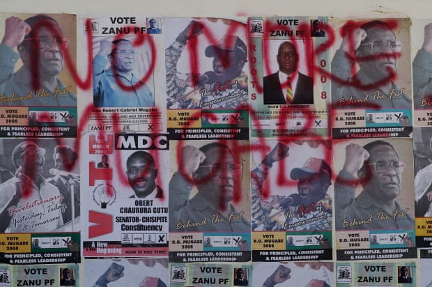  Mugabe election posters of are covered in opposition MDC slogans, in Harare, 2008.