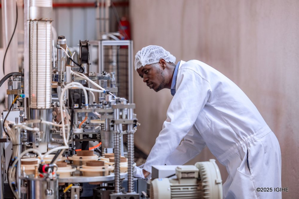 A member of staff inspects the cup-making machine at A-ZF Global Trading.