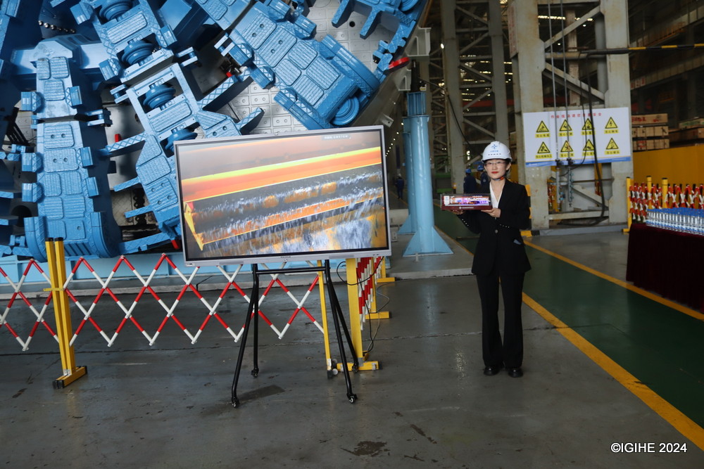 An employee of CCCC Tuanhe showing a model of manufactured Tunnel Boring Machines. 
