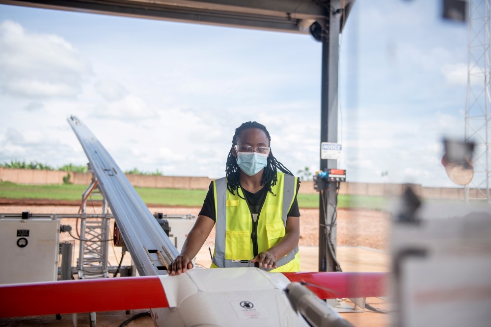 A female worker at Zipline operating a drone.