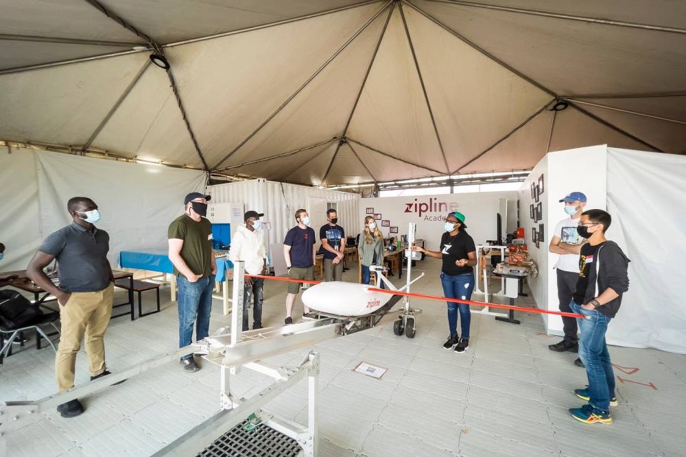 A female worker at Zipline taking guests through the process of flying a drone.
