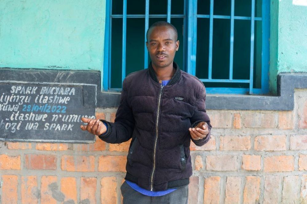 Alexis Mbarushimana, a Design Fellow at Spark Microgrants, shares insights during a community discussion in Bucyaba Village, Gakenke District — highlighting the key role Design Fellows play in supporting collaborative planning and local development.