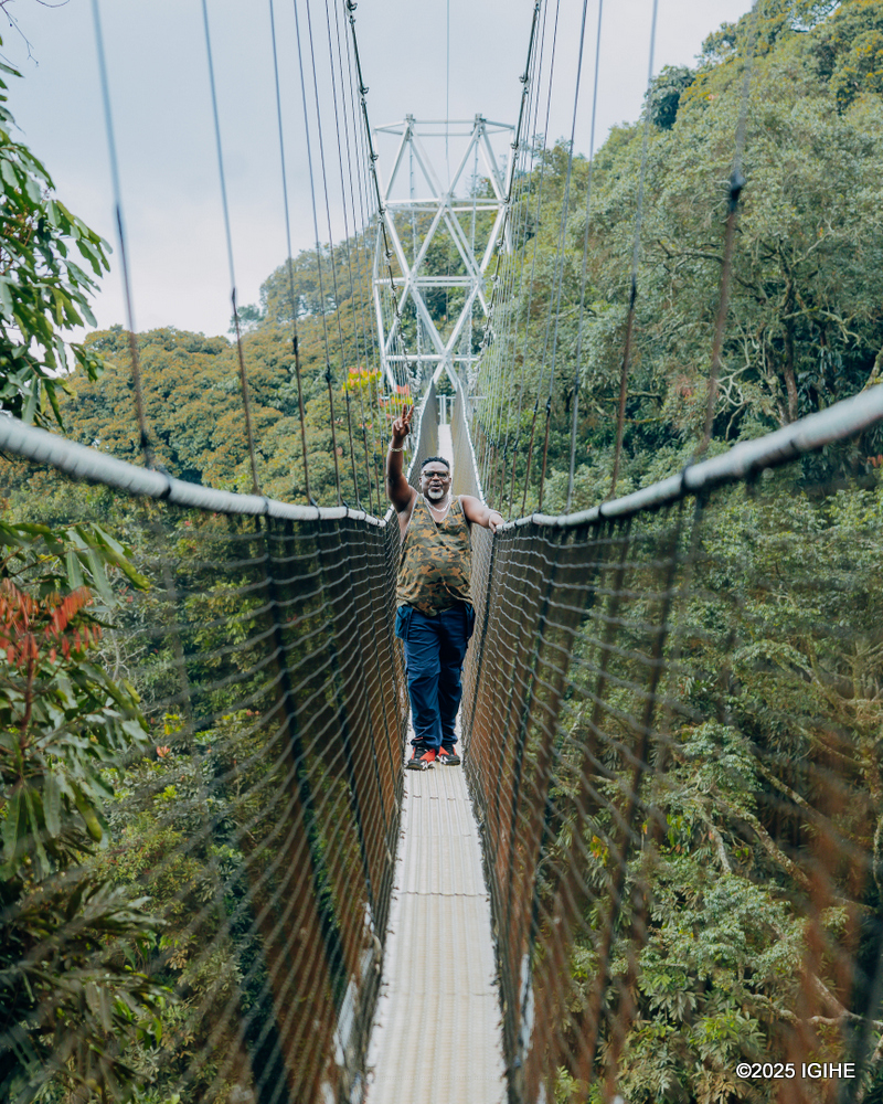 Ndimbati, a popular Rwandan film actor, enjoys the canopy walk.