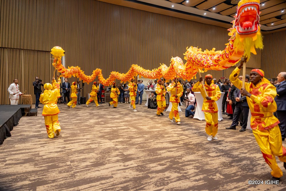 Young Rwandans performing dragon dance at the celebration. In the Chinese culture, the dragon represents good luck, strength and health.