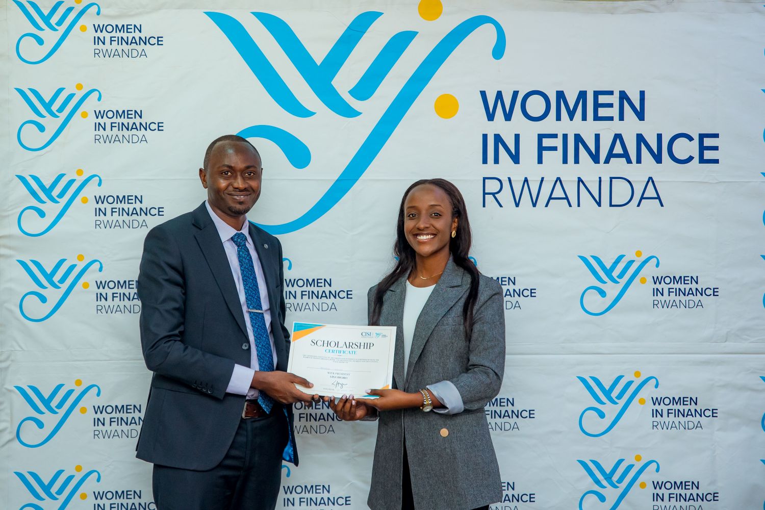 Ingrid Isimbi receives her scholarship certificate.