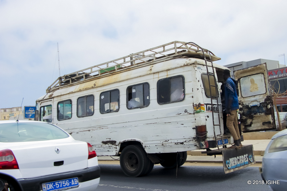 Public buses that transport locals in Dakar. The conveyor is always at the back of the bus
