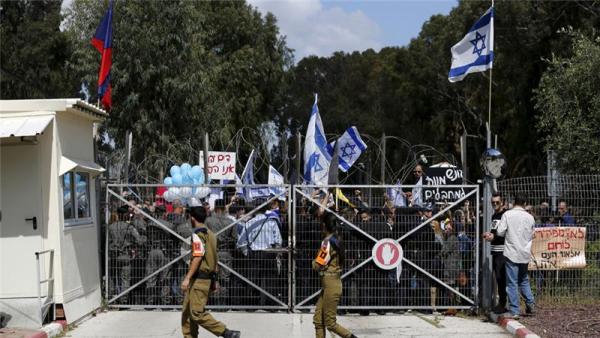 Israeli protesters outside a military court during a hearing for the accused Israeli soldier