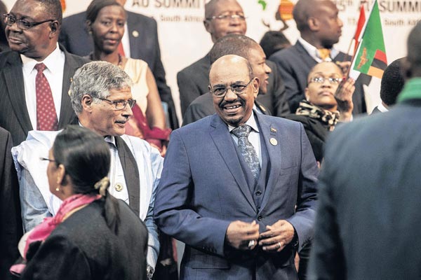 Sudanese President Omar al-Bashir arrives for a group photograph of leaders at the 25th African Union Summit in Sandton South Africa on June 14, 2015.