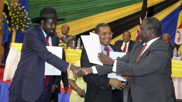 Riek Machar [R] is expected to arrived in the South Sudanese capital next week after signing a peace deal with President Kiir