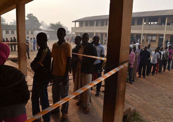 People queue at a polling station in the muslim district of PK 5 before voting on February 14, 2016, in Central African Republic.