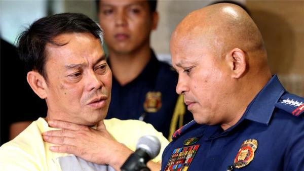 This photo from August shows Mayor Ronaldo Espinosa, left, talking to Philippine National Police chief Ronald dela Rosa
