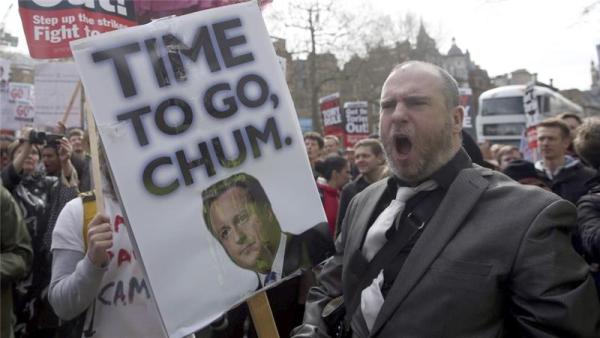 Demonstrators hold placards during a protest outside Downing Street in Whitehall, central London