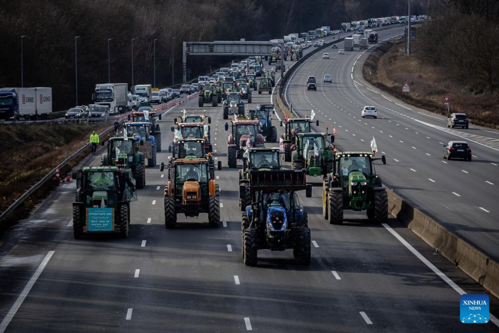 French farmers block a highway with their tractors during a protest in Longvilliers, near Paris, France, on Jan. 29, 2024. French farmers blocked motorways around Paris on Monday afternoon as they continued protesting against rising prices, red tape and "unfair competition" from other countries. (Photo by Aurelien Morissard/Xinhua)