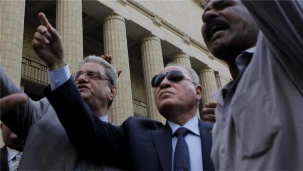 Egypt's justice minister [centre] faces resignation calls after comments about the prophet