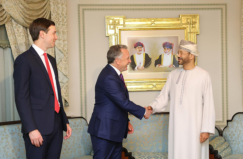 In this photo released by Oman's Foreign Ministry, U.S. special envoy Steve Witkoff (C) shakes hands with Omani Foreign Minister Sayyid Badr bin Hamad Al Busaidi (R) as Jared Kushner, U.S. President Donald Trump's son-in-law, looks on during a meeting in Muscat, Oman, February 6, 2026.