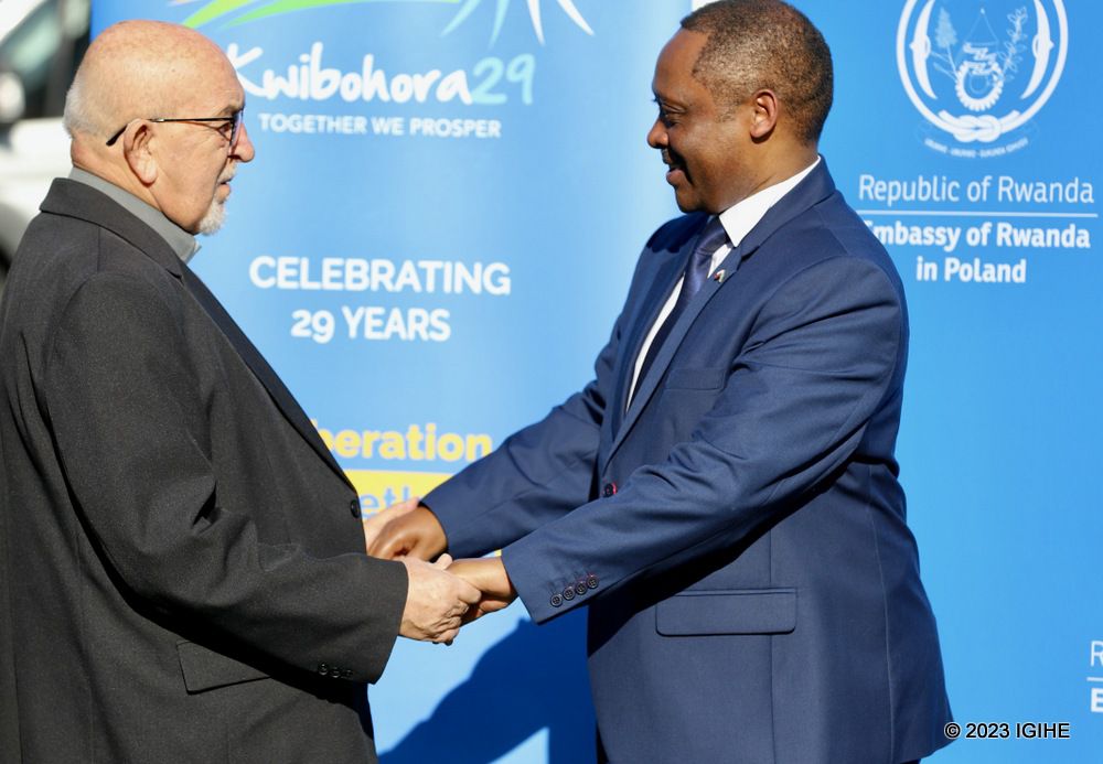 Father Stanislaw Urbaniak, friendship pact protector hailing from Poland exchanging greetings with Amb. Shyaka.