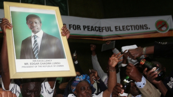 PF supporters in Lusaka celebrate while holding a portrait of Lungu