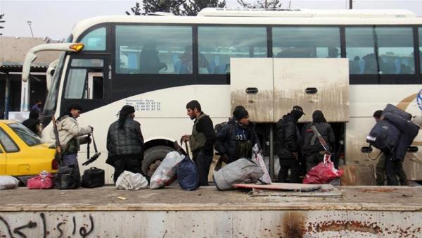 Syrian rebels arrive in the opposition-controlled Khan al-Assal region, west of Aleppo, after being evacuated
