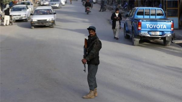An Afghan policeman keeps watch at a checkpoint in Farah province as the Taliban pose an imminent threa
