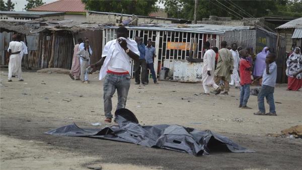 A body lies covered after an explosion in Maiduguri, Nigeria on Wednesday