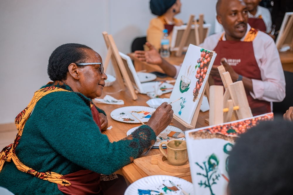 Mukangango painting a coffee tree at the event.