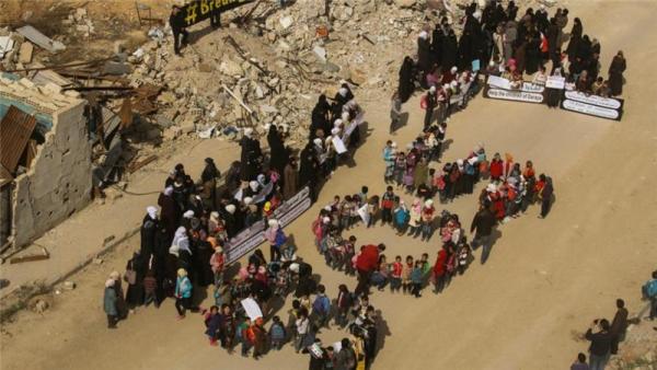 The children in the protest in Darayya lined-up to form the letters 'SOS