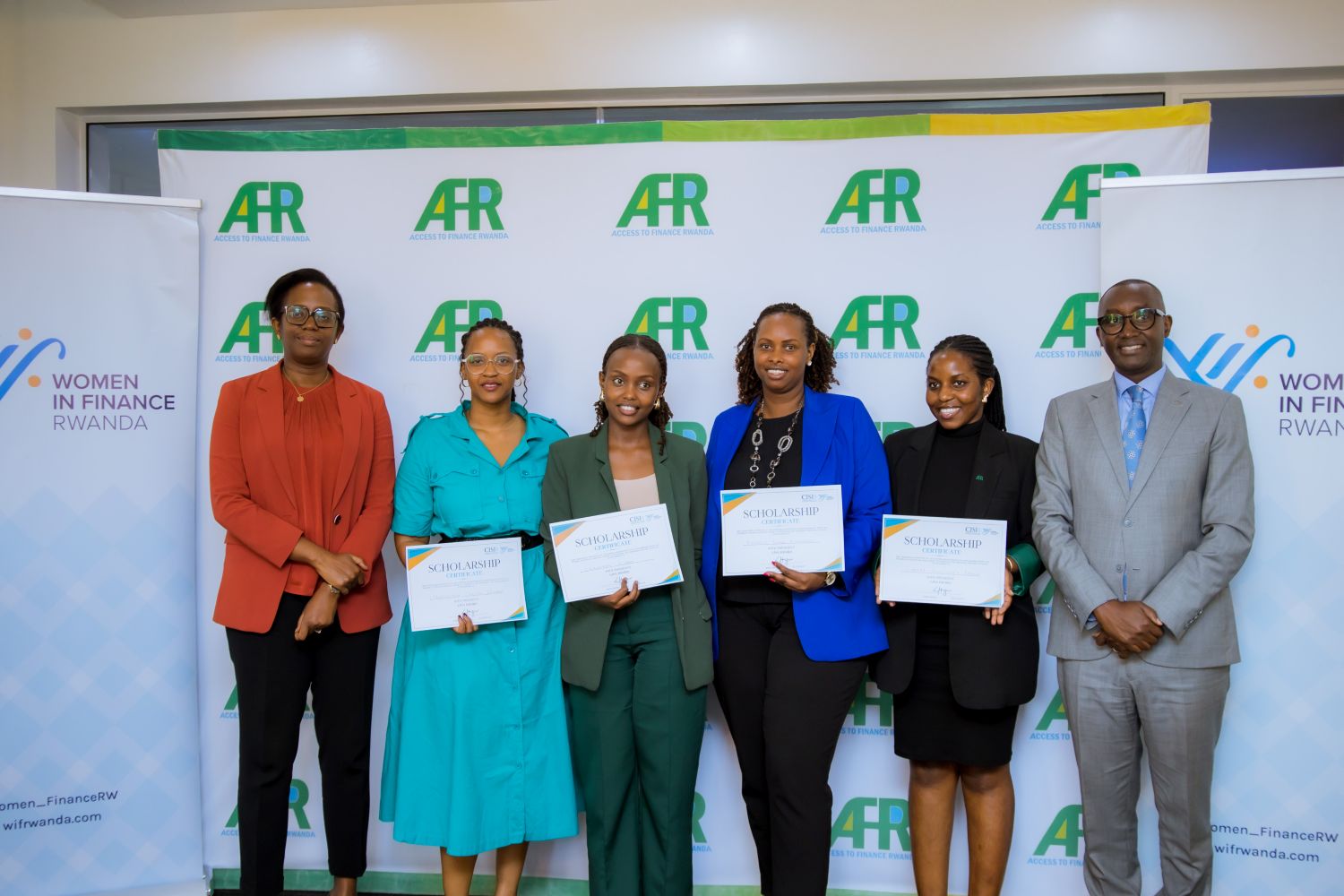 Dr. Diane Karusisi, CEO of Bank of Kigali and a WIFR Council and Institutional Member, and Jean Bosco Iyacu, CEO of Access to Finance Rwanda (AFR), pose for a photo with the four beneficiaries of the scholarship programme at AFR offices in Kacyiru on Wednesday, May 22, 2025.