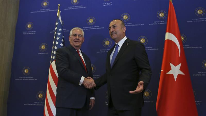 Mevlut Cavusoglu, right, shakes hands with Rex Tillerson on Thursday