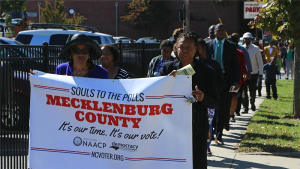 Churchgoers march together to a voting centre in Charlotte