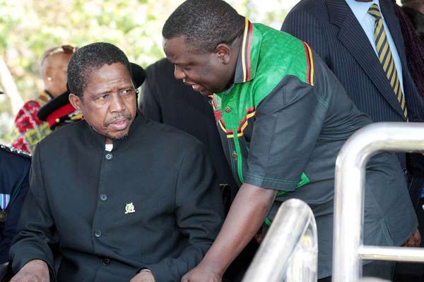 President Edgar Lungu (left) talks to Foreign Affairs minister Harry Kalaba during a military exhibition march to mark Zambia's 50th Independence celebration. Zambian voters go to the ballot on 11th August 2016.