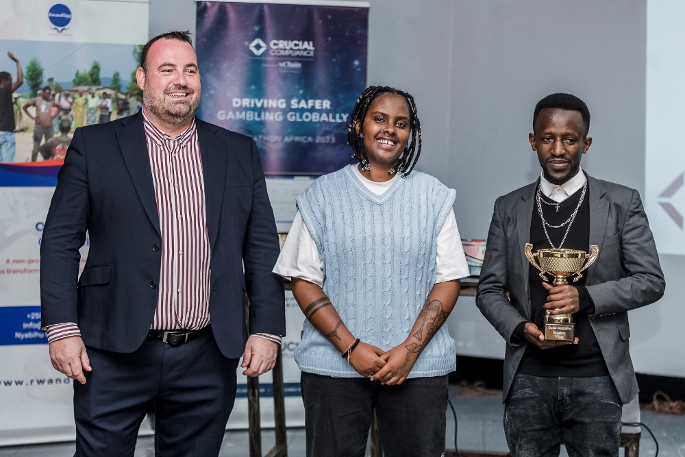 The CEO of Crucial Compliance, Paul Foster with singer Ariel Wayz and the winner in a group photo.