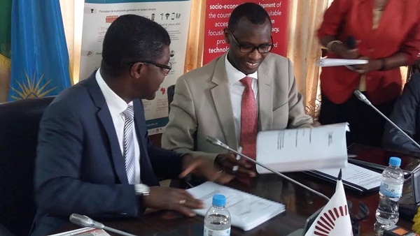 The Minister of Education, Dr Papias Musafiri Malimba and Thierry Zamahoun signing asgreements