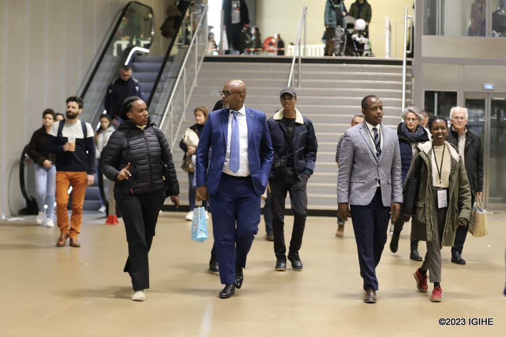 Yves Karatwa taking Amb. Nkulikiyimfura and Diane Sayinzoga through different parts of the exhibition. 