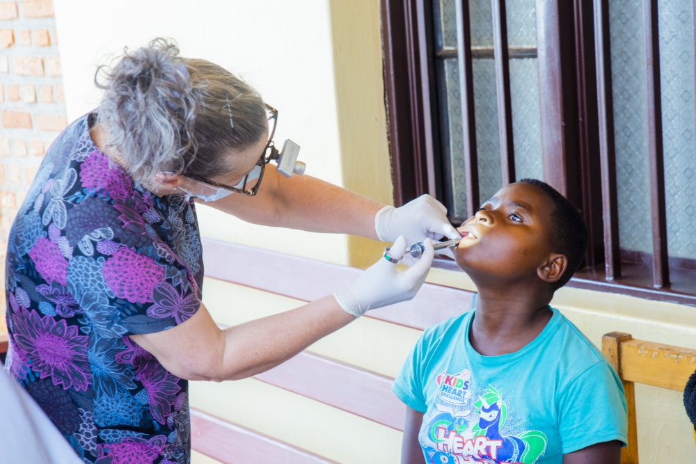 A specialist dentist from Canada attending to a patient at Gahanga Health Center. 